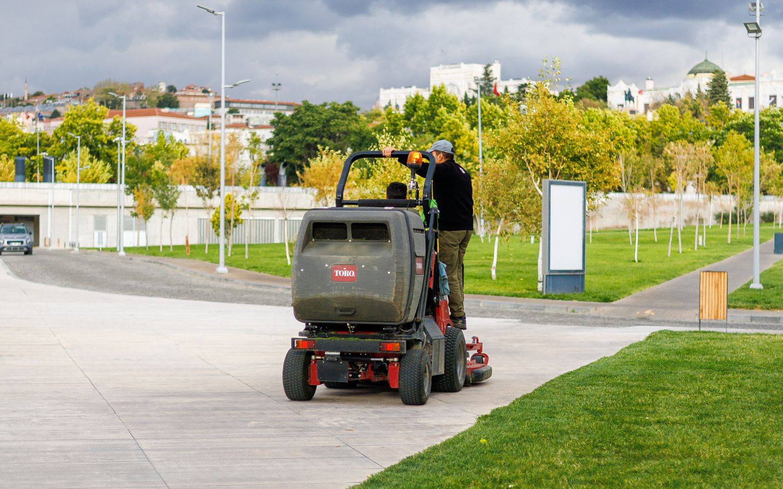Operator running a machine across a large lawn